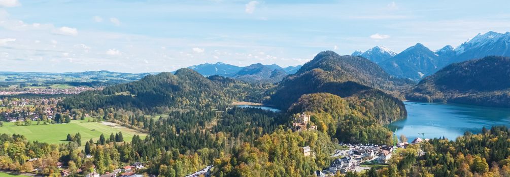 Beautiful nature of European Alps, landscape view of alpine mountains, lake and village on a sunny day, travel and destination scenery