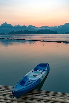 Paddle boat floating in a dam in southern of Thailand in the morning.