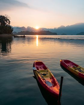 Paddle boat floating in a dam in southern of Thailand in the morning.