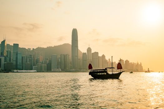 Hong Kong skyline with a traditional boat seen from Kowloon, Hong Kong, China.