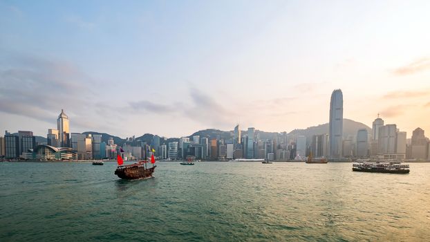 Hong Kong skyline with a traditional boat seen from Kowloon, Hong Kong, China.