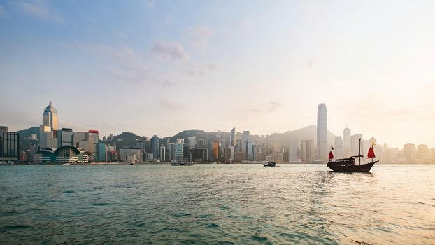 Hong Kong skyline with a traditional boat seen from Kowloon, Hong Kong, China.