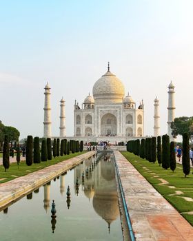 Taj Mahal front view reflected on the reflection pool, an ivory-white marble mausoleum on the south bank of the Yamuna river in Agra, Uttar Pradesh, India. One of the seven wonders of the world.