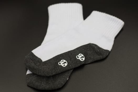 One pair of socks on a black background.