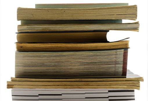 A pile of old and used books in front of a background with black-and-white bokeh, isolated, for reading