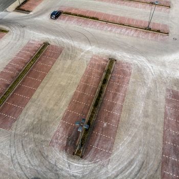 Oblique aerial photograph of an empty parking lot of a consumer market, abstract aerial view, made with drone