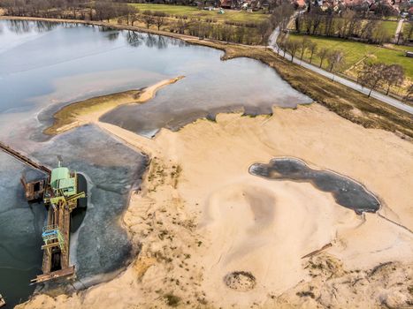 Aerial view of a sand mining area and the associated excavation lake, drone shot