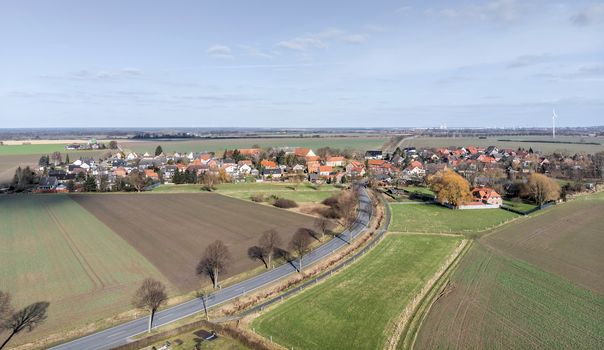 Aerial view of the access and transit road to a small village near Wolfsburg.Made with drone