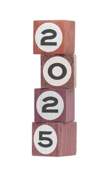 Four isolated hardwood toy blocks on white, saying 2025