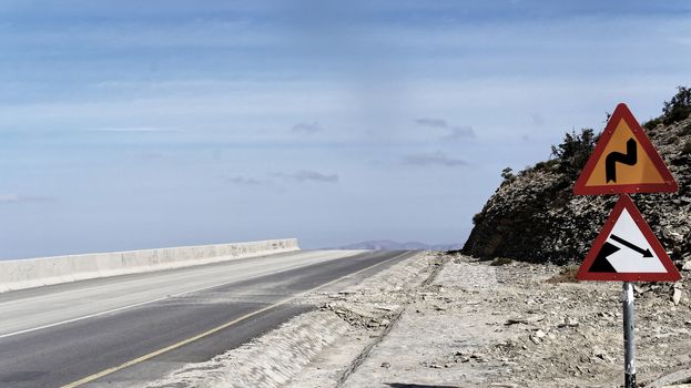 Dangerous road in Oman, with warning signs that have their justification, travel photo