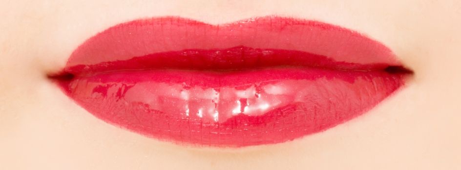 Female lips with glossy lipstick or lip gloss for make-up and beauty ads