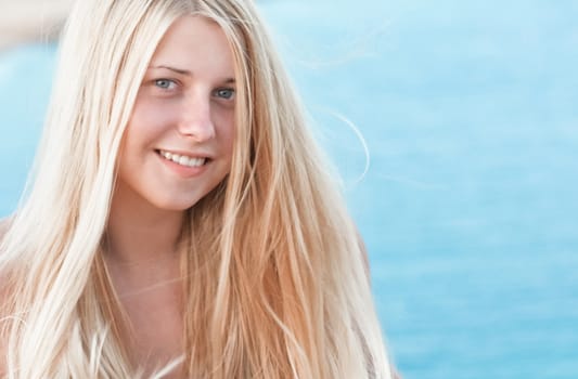 Woman with blond hair enjoying seaside and beach lifestyle in summertime, holiday travel and leisure concept