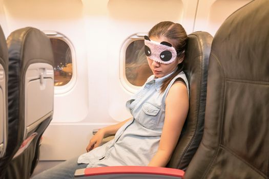 Asian woman traveller sleeping in the airplane