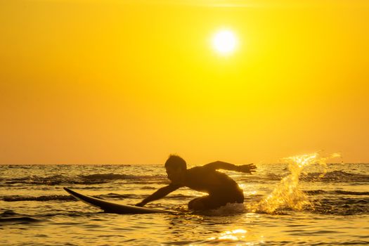 Surfing at Sunset. Outdoor Active Lifestyle. Summer water sport.