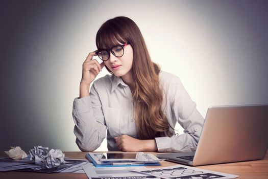 Feeling tired and stress. A stressed Asian business woman looks tired in her office