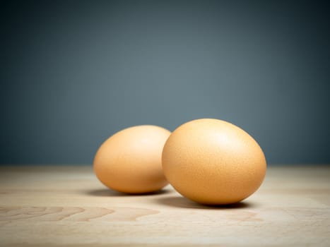 Close up two eggs on wooden table