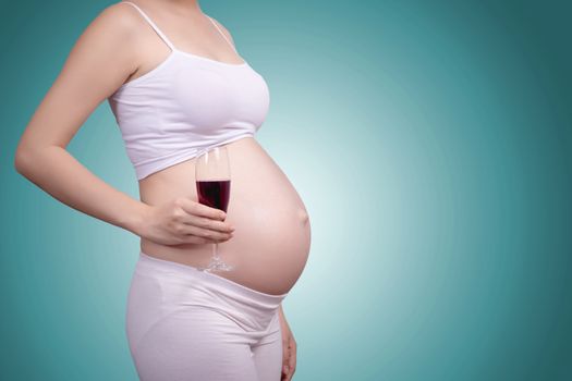 Pregnant healthy concept. A portrait of a Beautiful asian pregnant woman with glass of wine in hand.Clipping path include