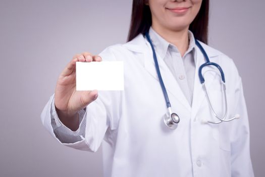 Healthy concept : Young Asian doctor with business card in hand , anonymous face