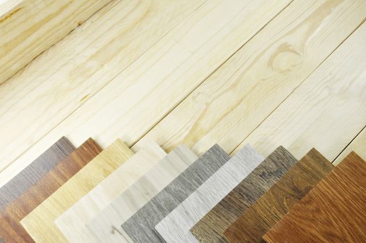 Wood laminate floor. Sample of laminate and vinyl tile on oak wooden background for new construction or renovate building or home. Venner. parquet