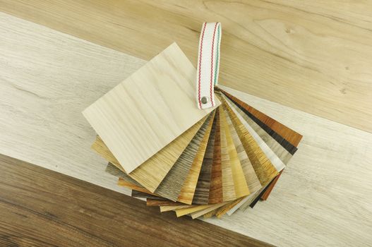 Wood laminate floor. Sample of laminate and vinyl tile on oak wooden background for new construction or renovate building or home. Venner. parquet