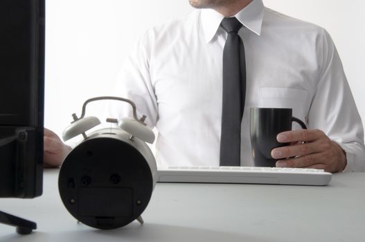 Smart businessman hold a cup of coffee and use computer for work.