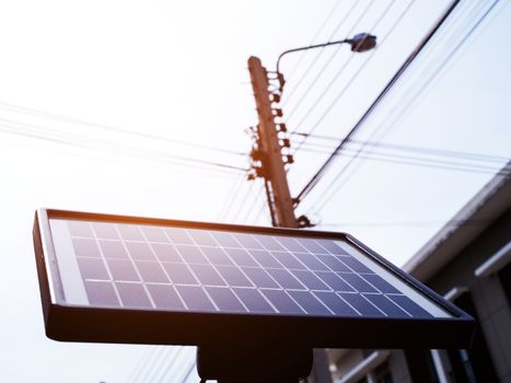 Solar cells, small solar panels on wall of house.