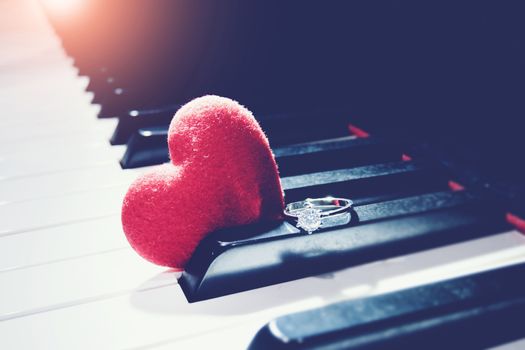 Ring and a hearts on piano ,vintage tone. Valentines Day background, wedding day. Love concept