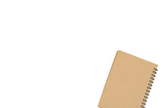 1 brown book placed at the bottom right hand corner of the image on a white background