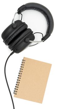 The book is at the bottom right of the picture. The headphone is tilted, positioned at the top left of the picture on a white background.