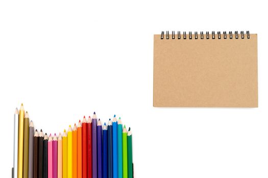 24 colored pencils arranged in a wave pattern on the bottom left of the picture and watercolor books in the upper right corner of the picture and all on a white background...