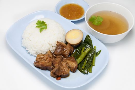 Stewed pork on rice isolated on white background.