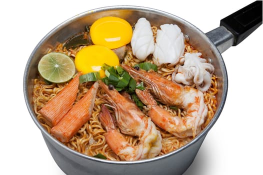 Bowl of spicy instant noodles isolated on white background. Topping with eggs, lemon, seafood, shrimp, squid, crab and coriander