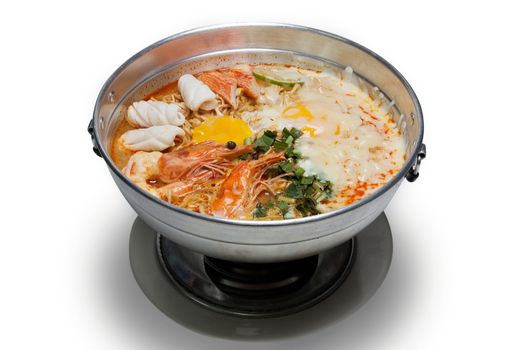 Pot of spicy instant noodles with Cheese isolated on white background. Topping with egg , seafood , shrimp, squid, crab ,lemon and coriander