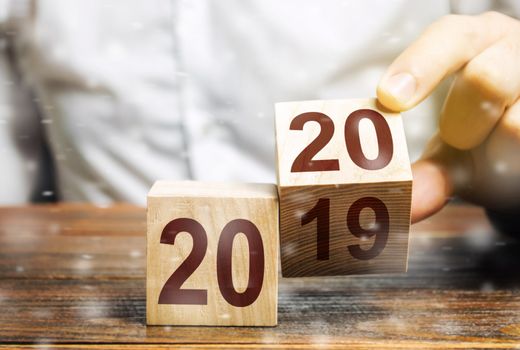 Two wooden blocks with numbers 2019 and 2020. Concept beginning of new year. New objectives. in next decade. Trends in the world. Build plans and goals. Moving into the future for new opportunities