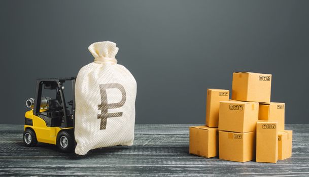 Forklift truck carries russian ruble money bag near the pile of boxes. Profit from trade and exchange of goods. Investments financing in production, taxes, income revenues and costs. superprofits