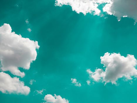 blue sky with white clouds and sunlight beam for background with color effect. cloudy blue sky abstract background