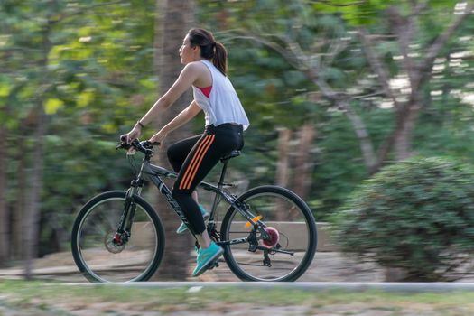 Bangkok, Thailand - March 15, 2017 : Unidentified people riding a bicycle by cycling on a bicycle lane in a outdoor park for exercise healthy