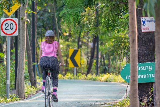 Bangkok, Thailand - March 15, 2017 : Unidentified people riding a bicycle by cycling on a bicycle lane in a outdoor park for exercise healthy