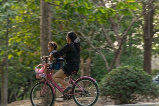 Bangkok, Thailand - March 15, 2017 : Unidentified people riding a bicycle by cycling on a bicycle lane in a outdoor park for exercise healthy