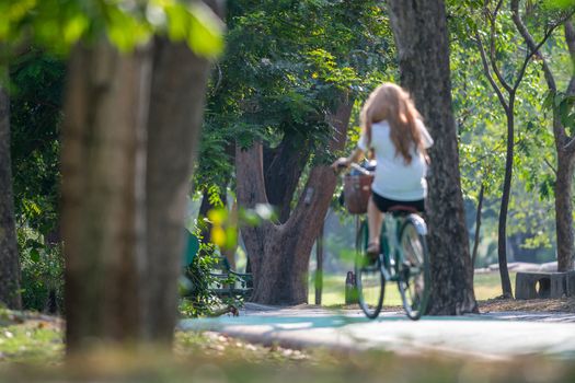 Bangkok, Thailand - March 15, 2017 : Unidentified people riding a bicycle by cycling on a bicycle lane in a outdoor park for exercise healthy