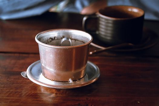 Traditional Laotian black coffee with coffee drip which is a popular local beverage