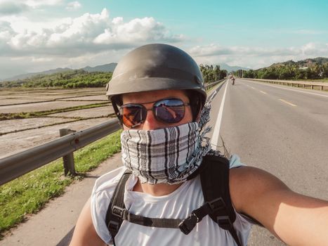 A tourist stopping for a selfie during a motorbike roadtrip in Vietnam
