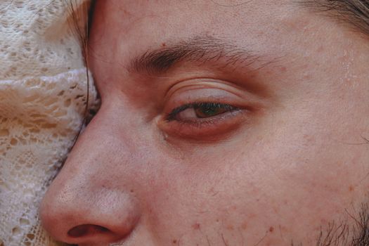 Close up of a Caucasian man's sleepy eye