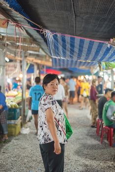 Bangkok, Thailand - June 17, 2017 : Unidentified woman shopping at Thai street food market vintage style can buy food vegetable and fruit in cheap price.