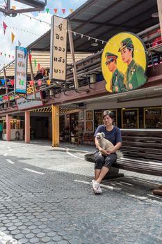 Prachuap Khiri Khan, Thailand - June 18, 2017 : Asian and her dog travel at Mercado de Plearnwan is tourist attraction in Hua Hin recreated retro village plus charming colorful accommodations.