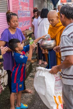 Chanthaburi, Thailand - July 9, 2017 : Unidentified Thai buddhism people in buddhist pray by Kathin Ceremony to make and off-season offering of robes and other needs to monks at Thai temple (Wat Thai)