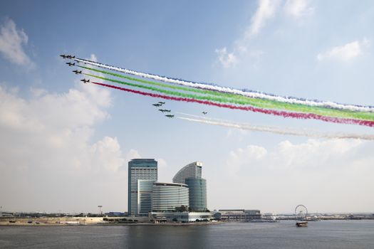 Emiratis Air Patrol flying above Festival City for the 46th National Day with UAE colors vapor trails, Dubai, United Arab Emirates