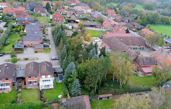  Suburban settlement in Germany with terraced houses, home for many families, aerial photograph taken at a slanting angle with the drone