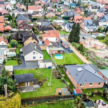  Suburban settlement in Germany with terraced houses, home for many families, aerial photograph taken at a slanting angle with the drone