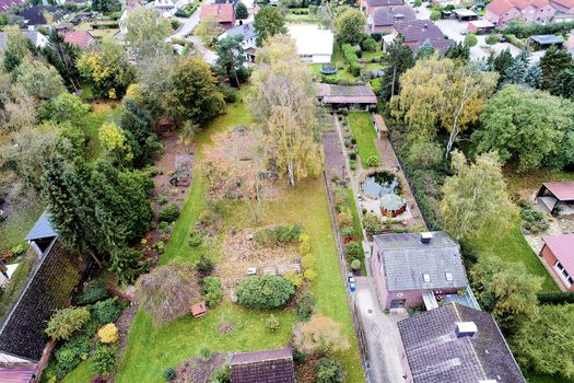 Aerial view of a large garden behind a detached house in a village in Germany